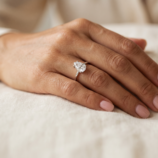 _Photorealistic_editorial_jewellery_photograph._A_woman_s_hand_resting_relaxed_on_a_soft_cream_linen_surface__fingers_gently_curled__wearing_Natural_soft_pink