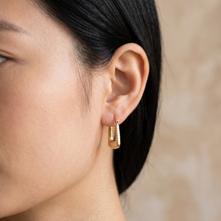 Model wearing 9K Yellow Gold Ribbed Creole Hoop Earrings - Sonny's Jewellers