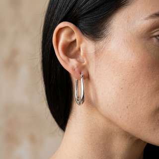 Model wearing 9K White Gold 12mm X 19mm Creole Hoop Earrings - Sonny's Jewellers