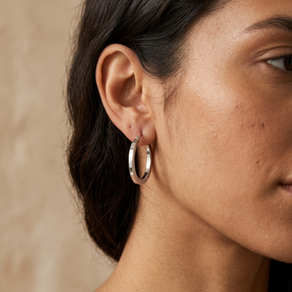 Model wearing 9K White Gold Square-Tube 26mm Creole Hoop Earrings - Sonny's Jewellers