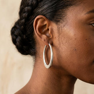 Model wearing 9K White Gold Oval Wave Creole Earrings - Sonny's Jewellers