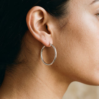Model wearing 9K White Gold 23mm Plain Hoop Earrings - Sonny's Jewellers