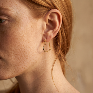 Model wearing 9K Yellow Gold Heart-Shaped Hoop Earrings - Sonny's Jewellers