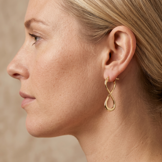 Model wearing 9K Yellow Gold Figure 8 Creole Earrings - Sonny's Jewellers
