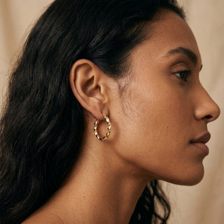 Model wearing 9K Yellow Gold Twisted Creole Earrings - Sonny's Jewellers