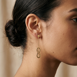 Model wearing 9K Yellow Gold Infinity Drop Earrings - Sonny's Jewellers
