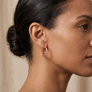 Model wearing 9K Rose Gold Twist Hoop Earrings - Sonny's Jewellers