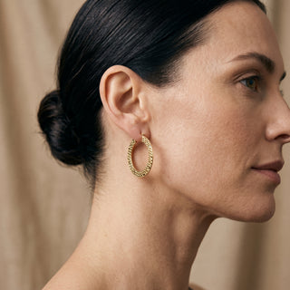 Model wearing 9K Yellow Gold 27.5mm Textured Creole Earrings - Sonny's Jewellers