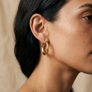 Model wearing 9K Yellow Gold Square-Tube Creole Earrings - Sonny's Jewellers