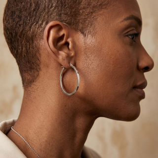 Model wearing 9K White Gold Rectangular-Tube 30mm Creole Hoop Earrings - Sonny's Jewellers