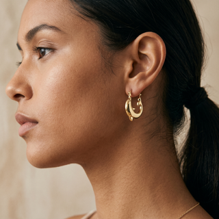 Model wearing 9K Yellow Gold 16mm x 19mm Dolphin Creole Hoop Earrings - Sonny's Jewellers