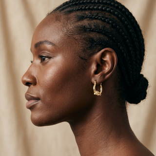 Model wearing 9K Yellow Gold 14mm x 16mm Dolphin Creole Hoop Earrings - Sonny's Jewellers