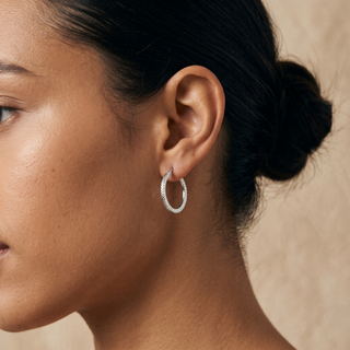 Model wearing 9K White Gold 15mm Cobra-Textured Creole Hoop Earrings - Sonny's Jewellers