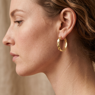 Model wearing 9K Yellow Gold Faceted Medium Hoop Earrings - Sonny's Jewellers