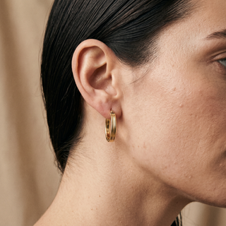 Model wearing 9K Yellow Gold Patterned Oval Creole Hoop Earrings - Sonny's Jewellers
