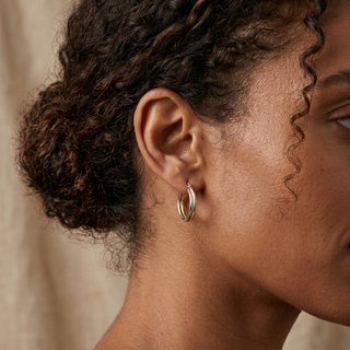 Model wearing 9K 2-Colour Gold Twist Crossover Creole Hoop Earrings - Sonny's Jewellers
