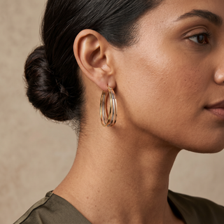 Model wearing 9K 3-Colour Gold Oval Triple-Loop Creole Hoop Earrings - Sonny's Jewellers