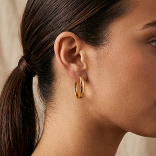 Model wearing 9K Yellow Gold Huggie Hoop Earrings - Sonny's Jewellers