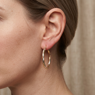 Model wearing 9K Tri-Gold Twist Hooped Earrings - Sonny's Jewellers