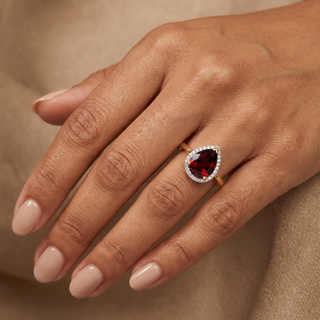 Model wearing 9K Yellow Gold Pear Garnet & Diamond Halo Ring - Sonny's Jewellers