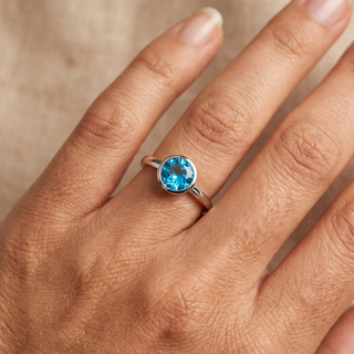 Model wearing 9K White Gold Round Blue Topaz Solitaire Ring - Sonny's Jewellers