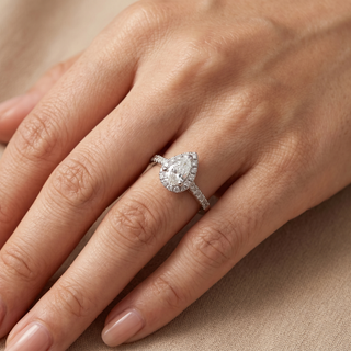 Model wearing Platinum 0.60ct Pear Brilliant Cut Diamond Halo Ring - Sonny's Jewellers
