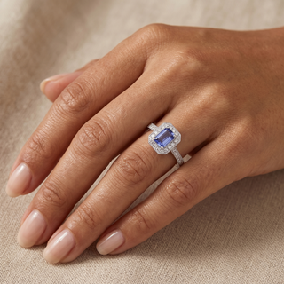 Model wearing 9K White Gold Emerald Cut Tanzanite & Diamond Halo Ring - Sonny's Jewellers