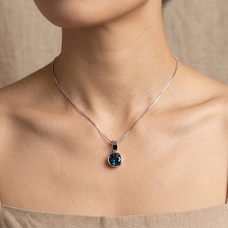 Model wearing 9K White Gold Blue Topaz Pendant - Sonny's Jewellers