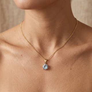Model wearing 9K Yellow Gold 5mm Round Aquamarine Pendant - Sonny's Jewellers