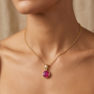 Model wearing 9K Yellow Gold 5mm Round Ruby Pendant - Sonny's Jewellers