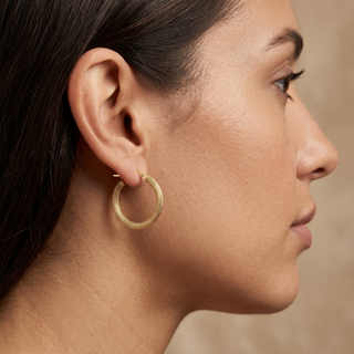 Model wearing 9K Yellow Gold Textured Hoop Creole Earrings - Sonny's Jewellers